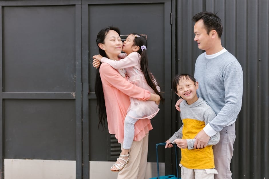 Asian family embracing and enjoying time together outdoors, showcasing love and inclusion.