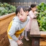 Children with Down syndrome enjoying a garden experience.