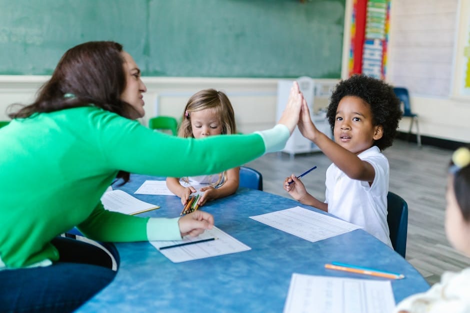 A teacher and students enjoying a high five during a classroom learning activity.