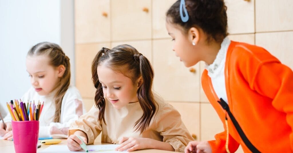 Children engaged in a fun art class, drawing and learning together at school.