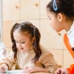 Children engaged in a fun art class, drawing and learning together at school.