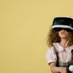 Curly-haired girl wearing VR headset and controllers, exploring virtual reality.