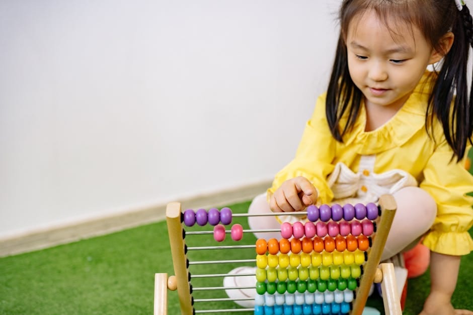 A young girl enjoying an educational moment with a vibrant abacus, teaching counting and fun.