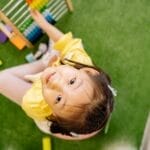 Happy child playing with abacus indoors. Perfect for educational and playful themes.