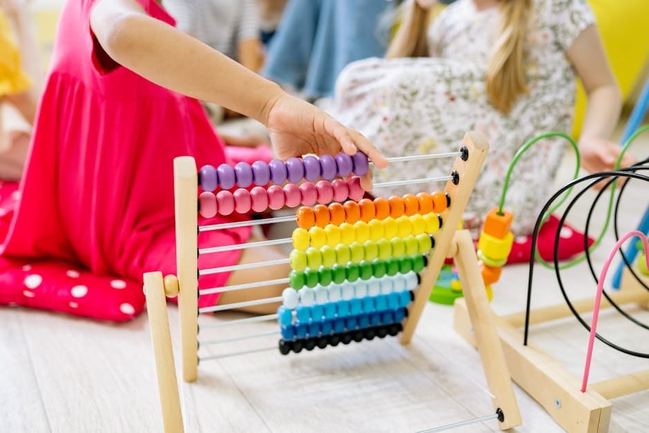 Children actively learning with a colorful abacus in a preschool setting, enhancing educational fun.