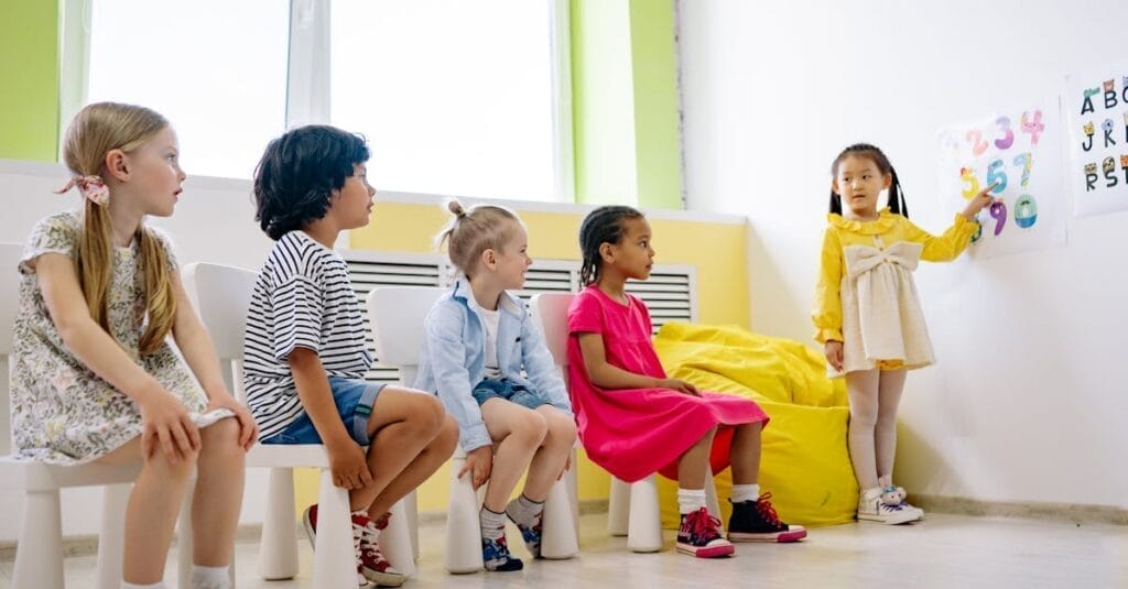 Children engaging in an interactive classroom lesson with colorful visuals, promoting diversity and education.