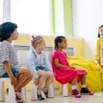 Children engaging in an interactive classroom lesson with colorful visuals, promoting diversity and education.