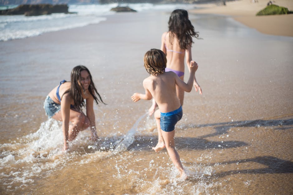 A family enjoys a sunny day on a Portuguese beach, splashing in the waves.