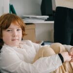 A young boy in a therapy session sitting comfortably indoors, emphasizing child development.