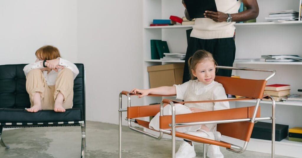 Children engage in a therapy session while the therapist observes with a clipboard.