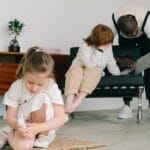 Young girl engaged in play therapy with psychologist's guidance indoors.