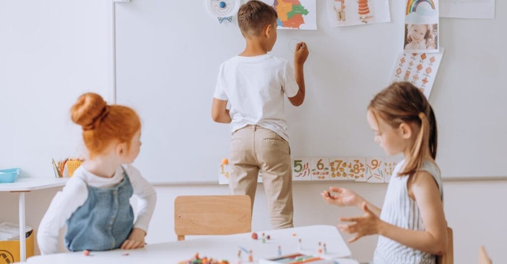 Young children engaging in creative activities in a vibrant classroom.