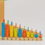 Close-up of a colorful wooden counting toy with numbers and shapes, perfect for preschool learning.