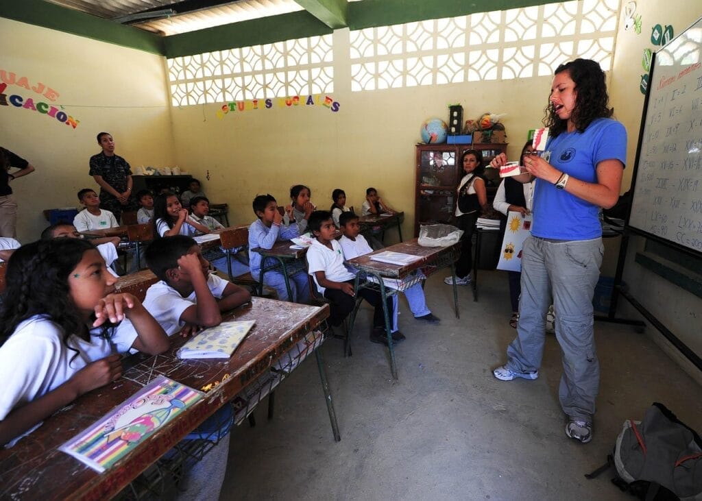 school, classroom, boys, girls, students, teacher, female, woman, ecuador, teaching, tables, chairs, teacher, teacher, teacher, teacher, teacher, teaching, teaching