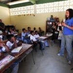 school, classroom, boys, girls, students, teacher, female, woman, ecuador, teaching, tables, chairs, teacher, teacher, teacher, teacher, teacher, teaching, teaching