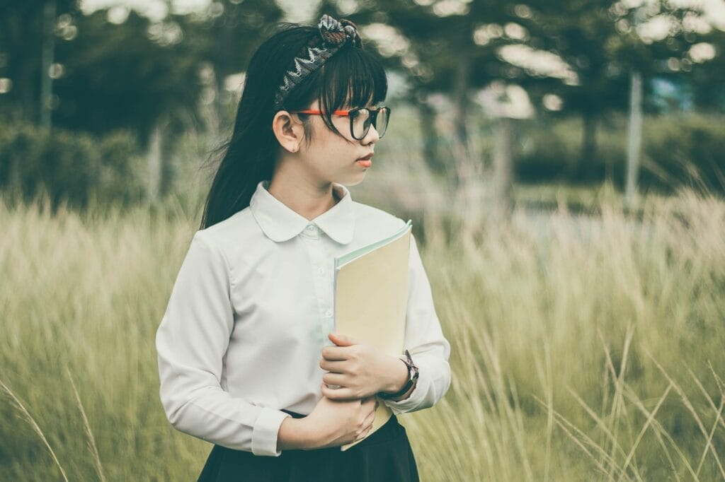 asian, nature, student, book, child, girl, uniform, school uniform, eyeglasses, field, grass, kid, looking away, outdoors, portrait, student, student, student, student, student