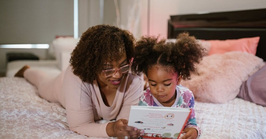 A mother and daughter enjoying a bedtime story, fostering togetherness and literacy.