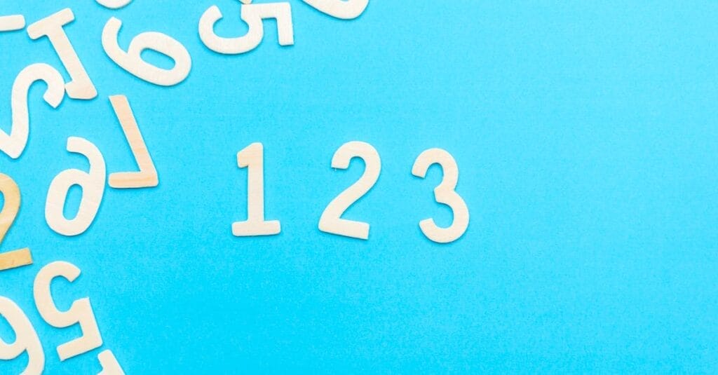 Creative layout of white numbers on a bright blue background, focusing on '123'.