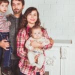 A joyful family posing together in a cozy living room, embodying love and togetherness.