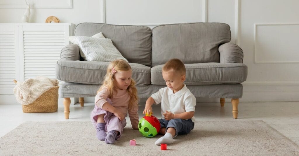 Two kids engaging with a toy in a cozy living room setting, fostering creativity.