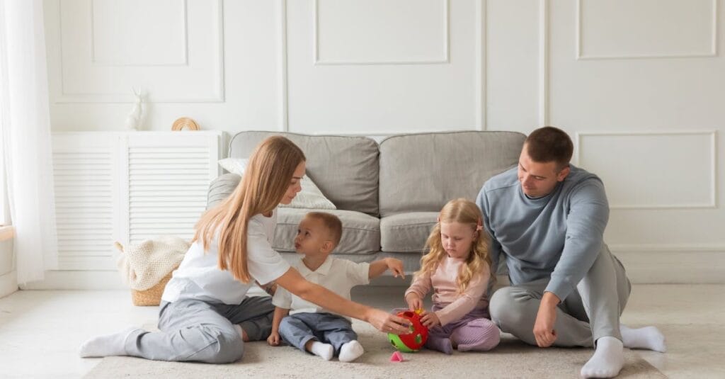 Family bonding time on the carpet in a cozy living room setting.