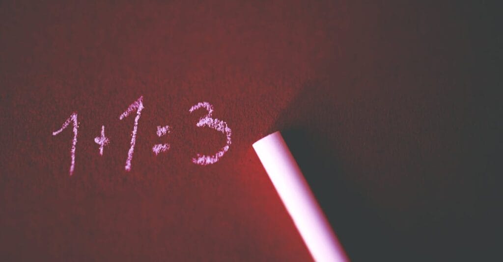 Close-up of a chalkboard with a humorous math error showing 1+1=3 written in chalk.