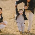 Family enjoying playful soccer game outdoors, capturing joyful moments.