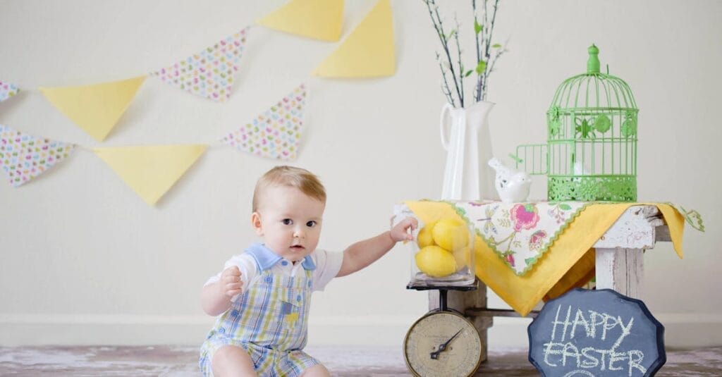 Charming baby enjoying a playful Easter scene with decorations inside.