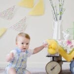 Charming baby enjoying a playful Easter scene with decorations inside.