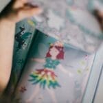 A child enjoying a colorful fairy tale book indoors, focusing on fantasy illustrations.