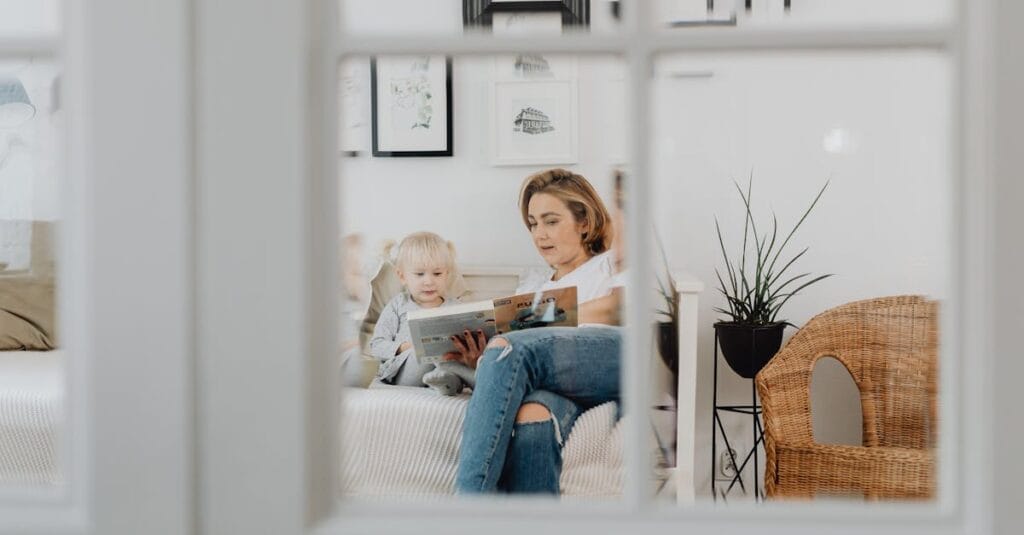 A mother and her daughter reading together in a cozy bedroom setting, fostering learning and bonding.