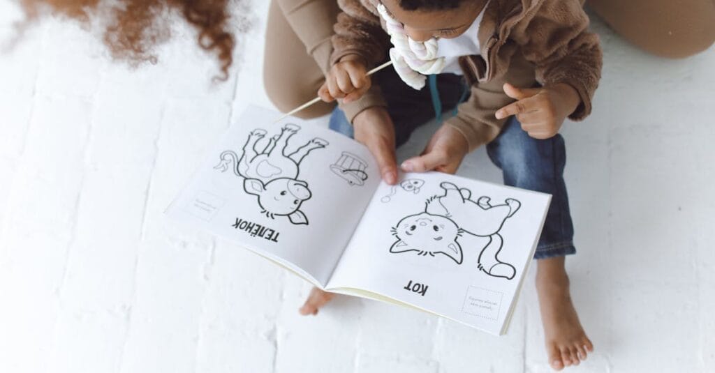 Mother and child enjoying a storytelling session with a book on a white floor.