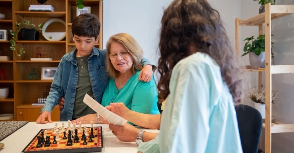 Family bond strengthened through chess at home, featuring multiple generations.