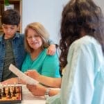 Family bond strengthened through chess at home, featuring multiple generations.