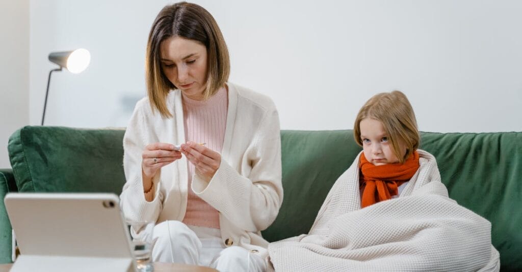 A mother and daughter engage in a telehealth session at home for health concerns.