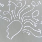 Chalk drawing of a head with swirling arrows represents mental activity and thought process.