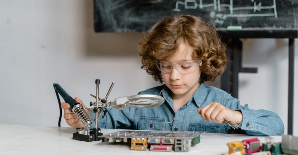 Child working on electronics with a soldering tool and circuit board, showcasing STEM learning.