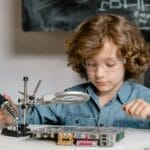 Child working on electronics with a soldering tool and circuit board, showcasing STEM learning.