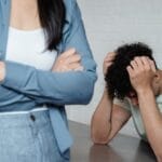 A couple experiencing relationship stress and conflict in an indoor setting, illustrating discord and tension.