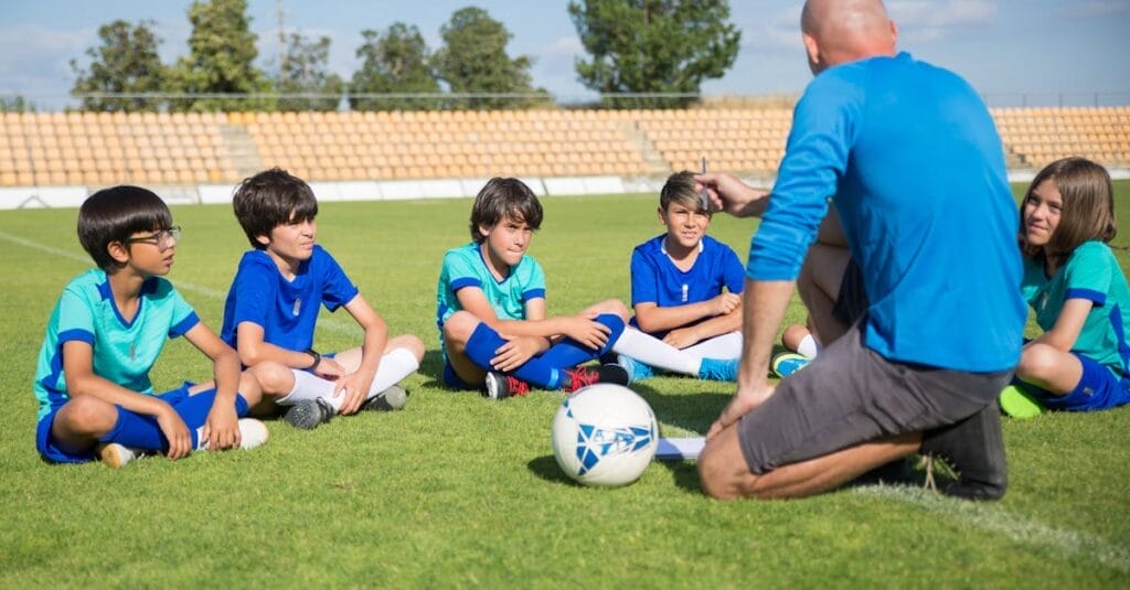 Children gather for a soccer coaching session on a sunny day in Portugal.