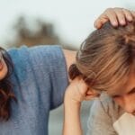 A mother offers support to her discouraged teenager son, portraying love and understanding.